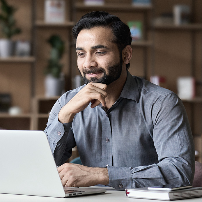 A man watching a CPD webinar on his laptop