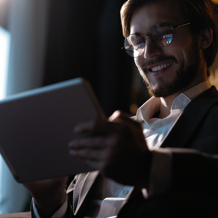 a man scrolling on his tablet